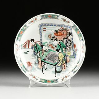 A QING DYNASTY FAMILLE VERTE ENAMELED LEISURE PLATE, "Ladies Playing the Board Game Go by a Dragon Screen," KANGXI MARK, 1644-1912,