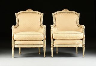 A PAIR OF LOUIS XVI STYLE SILK UPHOLSTERED PARCEL GILT AND PAINTED WOOD BERGÃˆRES, FIRST HALF 20TH CENTURY,