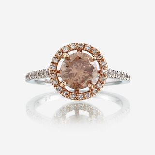 A colored diamond, diamond, and eighteen karat two tone gold ring