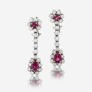 A pair of diamond, ruby, and fourteen karat white gold earrings