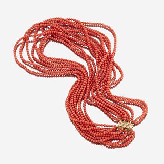 A coral and fourteen karat gold necklace
