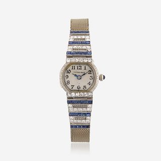 An Art Deco platinum, fourteen karat white gold, diamond, and synthetic sapphire, bracelet wristwatch