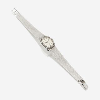 A fourteen karat white gold and diamond, bracelet wristwatch, Omega