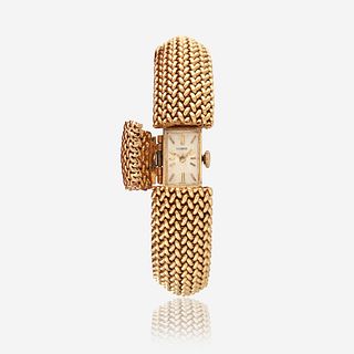 A fourteen karat gold, covered dial bracelet wristwatch
