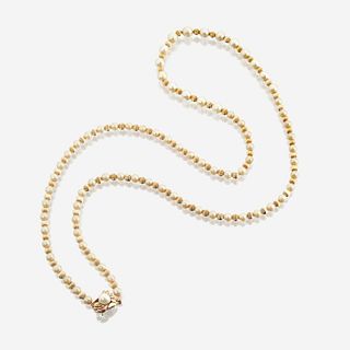 A cultured pearl, bead, and fourteen karat gold necklace