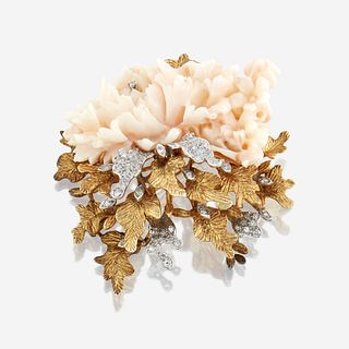 An eighteen karat gold, coral, and diamond brooch