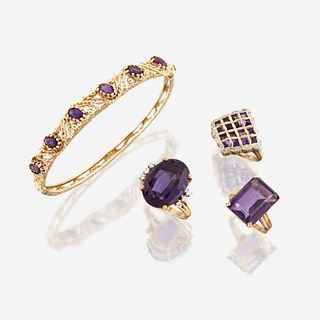 A collection of four pieces of amethyst and gold jewelry