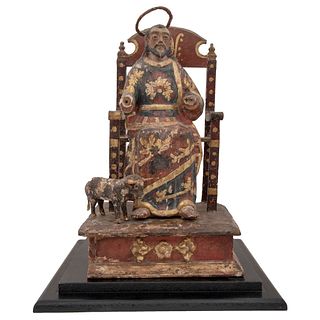 ENTHRONED ST LUCAS  MEXICO, 19TH CENTURY Gilded and polychrome wood carving. 21.6 x 9.4" (55 x 24 cm)