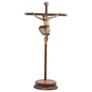 CRUCIFIED CHRIST MEXICO, 19TH CENTURY Carved and polychrome wood, with a circular base. 33.4 x 16.5" (85 x 42 cm)