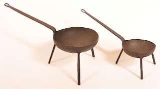 Two Wrought Iron Kettles on Tripod Bases.