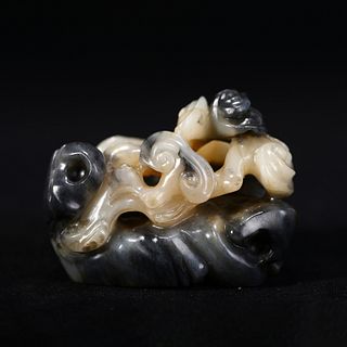 A BLACK AND WHITE JADE BRUSH REST