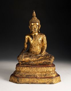 Buddha figure; Thailand, 19th century.
Patinated bronze and fine gold.