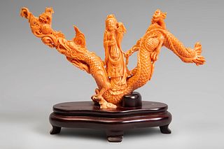 Guanyin with dragon. China, 20th century.
Coral.
Wooden base.