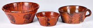 Three Pennsylvania redware bowls, 19th c., with ma