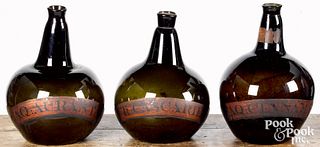 Three blown olive glass apothecary bottles