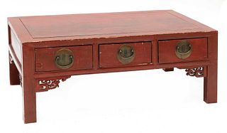 A Chinese low red-lacquered coffee table,