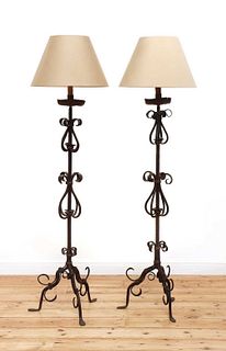 A pair of wrought iron standard lamps,