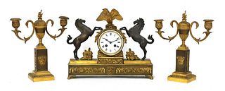 A French two-colour gilt-bronze three-piece clock garniture,