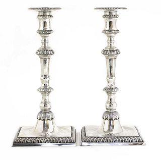 A pair of cast silver candlesticks,