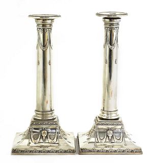 A pair of Edwardian silver-plated neoclassical candlesticks,