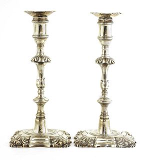 A pair of cast silver table candlesticks,