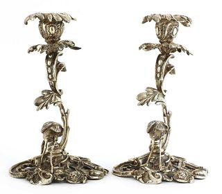 A pair of cast silver-plated candlesticks,