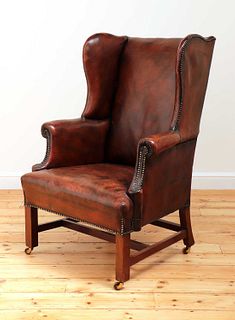 A George III mahogany-framed leather wingback armchair,