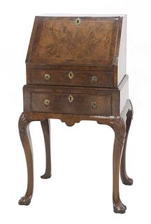 A small George II-style walnut and feather-banded bureau on stand,