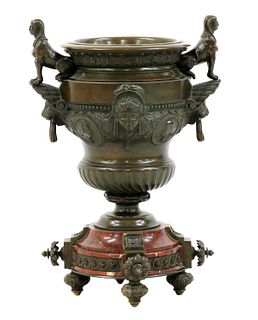A bronze and marble urn centrepiece,