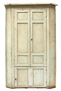 A large George III painted pine corner cupboard,