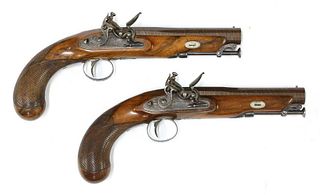 A pair of late flintlock travelling pistols,