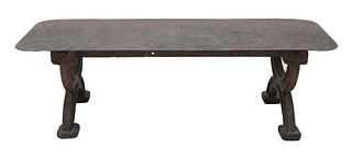 An industrial cast and sheet iron coffee table,