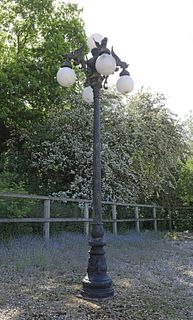 A Victorian-style cast and painted aluminium street lamp,