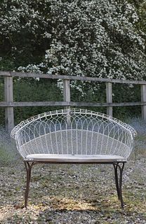 A Victorian wirework double garden seat,
