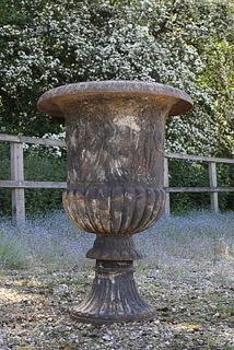 A cast iron campana garden urn,