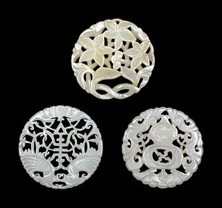 Three Chinese Pale Celadon Jade Circular Reticulated Plaques