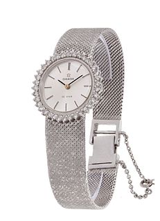 OMEGA De Ville watch, years 30-40, made in 18 Ct. white gold for women. Round dial with stroke numerals and baton hands. It has a bezel with 40 brilli