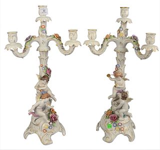 Pair of German Porcelain Candelabras, mounted with orange and pink flowers and two puttis each, marked to the underside "Made in Germany, 1817", heigh