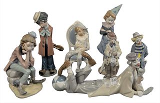 Seven Piece Group of Lladro Porcelain Figures, to include three clown figures, a trumpet player, a harlequin dressed boy holding a kitten; along with 