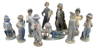 Group of Ten Porcelain Lladro Figurines, to include several boys with puppies, baseball bat, flowers, clown, etc., height of tallest 10 1/2 inches.