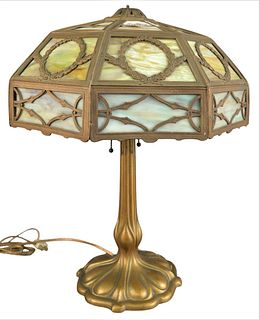 Slag Glass Panel Table Lamp, having two lights and wreath form brass mounts, overall height 23 inches.
