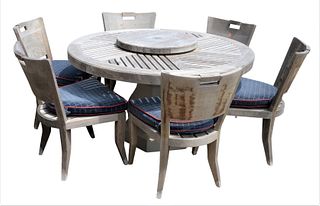 Seven Piece Sutherland Teak Outdoor Patio Set, having six matching side chairs with custom seat cushions, round table on cement pedestal and lazy Susa