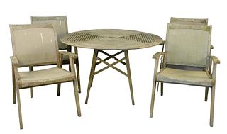 Teak Outdoor Round Table and Four Armchairs, seat height 18 inches, height 28 1/2 inches, diameter 47 1/4 inches. Provenance: The Estate of Diana Atwo