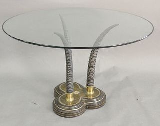 Maitland Smith Hollywood Regency Glass Top Circular Table, raised on three sculpted horns on a leather covered base, height 29 inches, diameter 48 inc