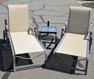 Four Piece Outdoor Set, to include a pair of chaises, an umbrella and a side table.