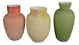 Group of Three Mount Washington Coralene Vases, in pink, yellow, and green, heights 6 3/4, 6 3/4, and 7 1/2 inches.