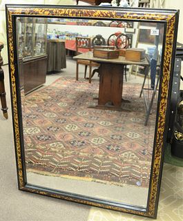 Baroque Style Ebonized and Faux Tortoiseshell Painted Rectangular Mirror, having a cushion molded frame, height 48 inches, width 36 inches. Provenance