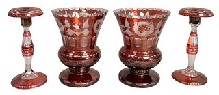 Two Pairs of Cranberry Cut to Clear Glass, to include a pair of candlesticks having flared rims, along with a pair of vases with castle, bird, and sta