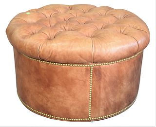 O. Henry House Round Pouf, having tufted brown leather and brass tacks, height 16 inches, diameter 29 inches.
