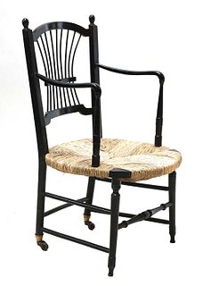 An ebonised 'Sussex' armchair,